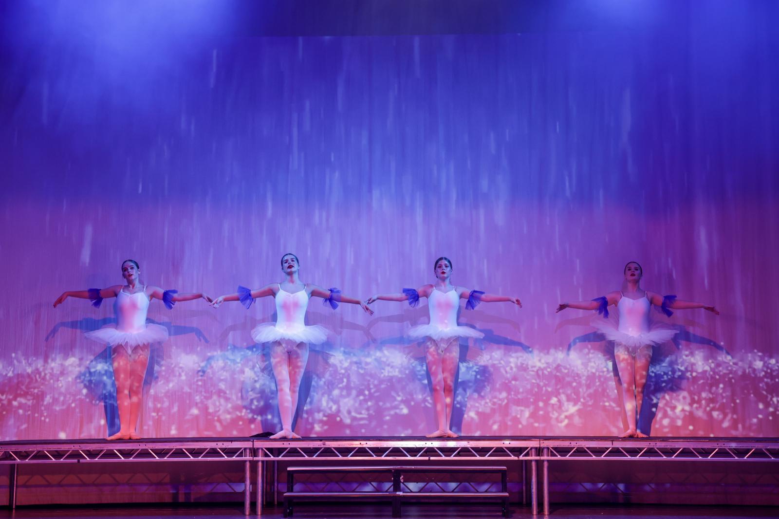 Four ballerinas in tutus on stage