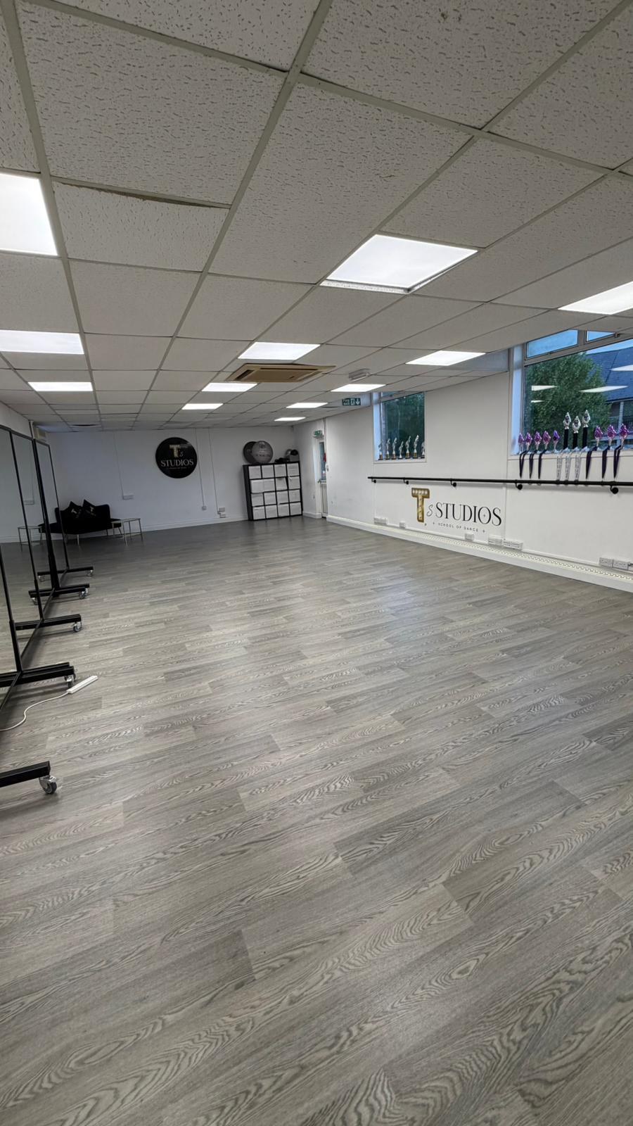 T's Studios dance floor with ballet barre and window