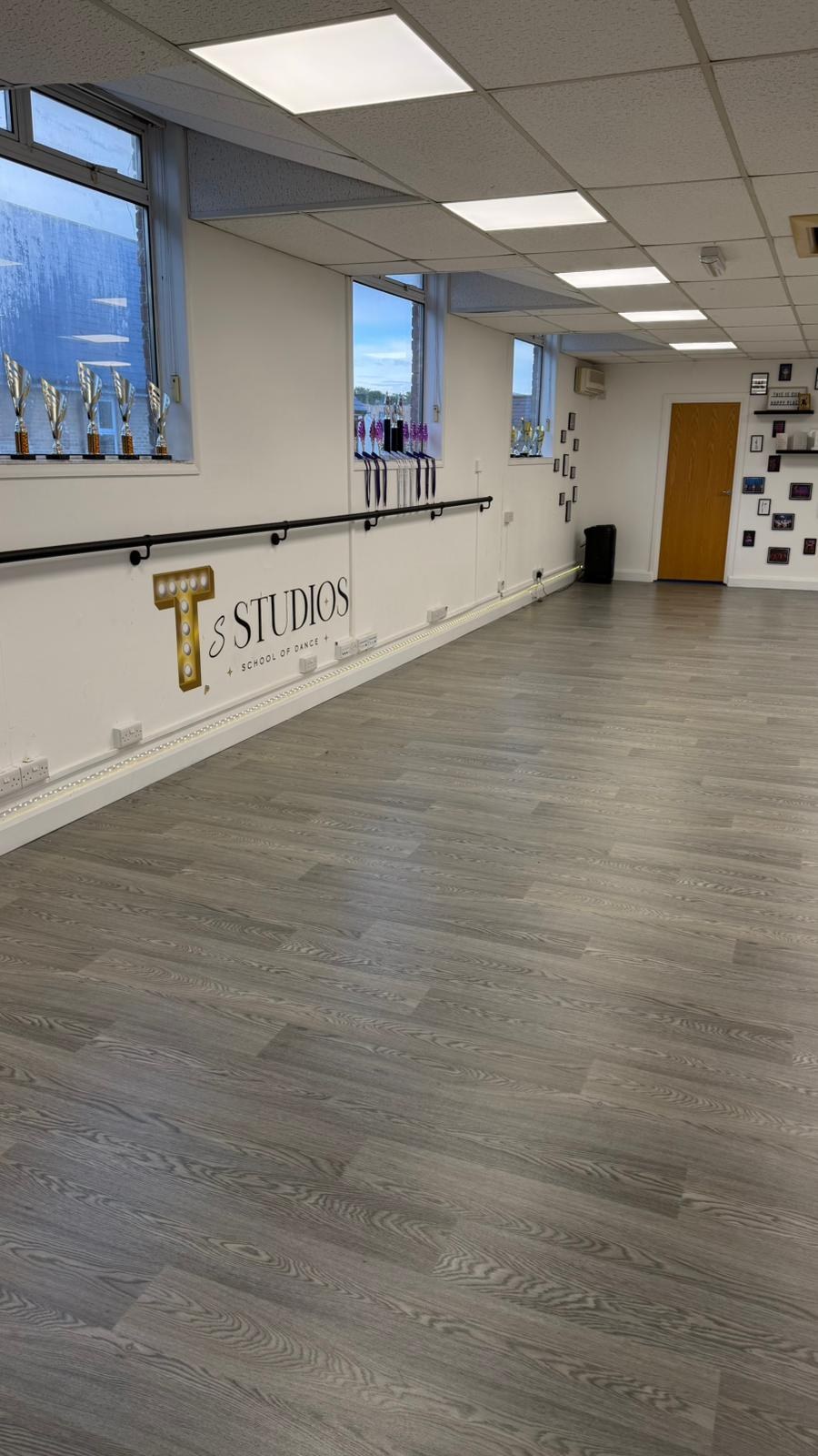 Inside T's Studios — ballet barre, mirrors and trophy display